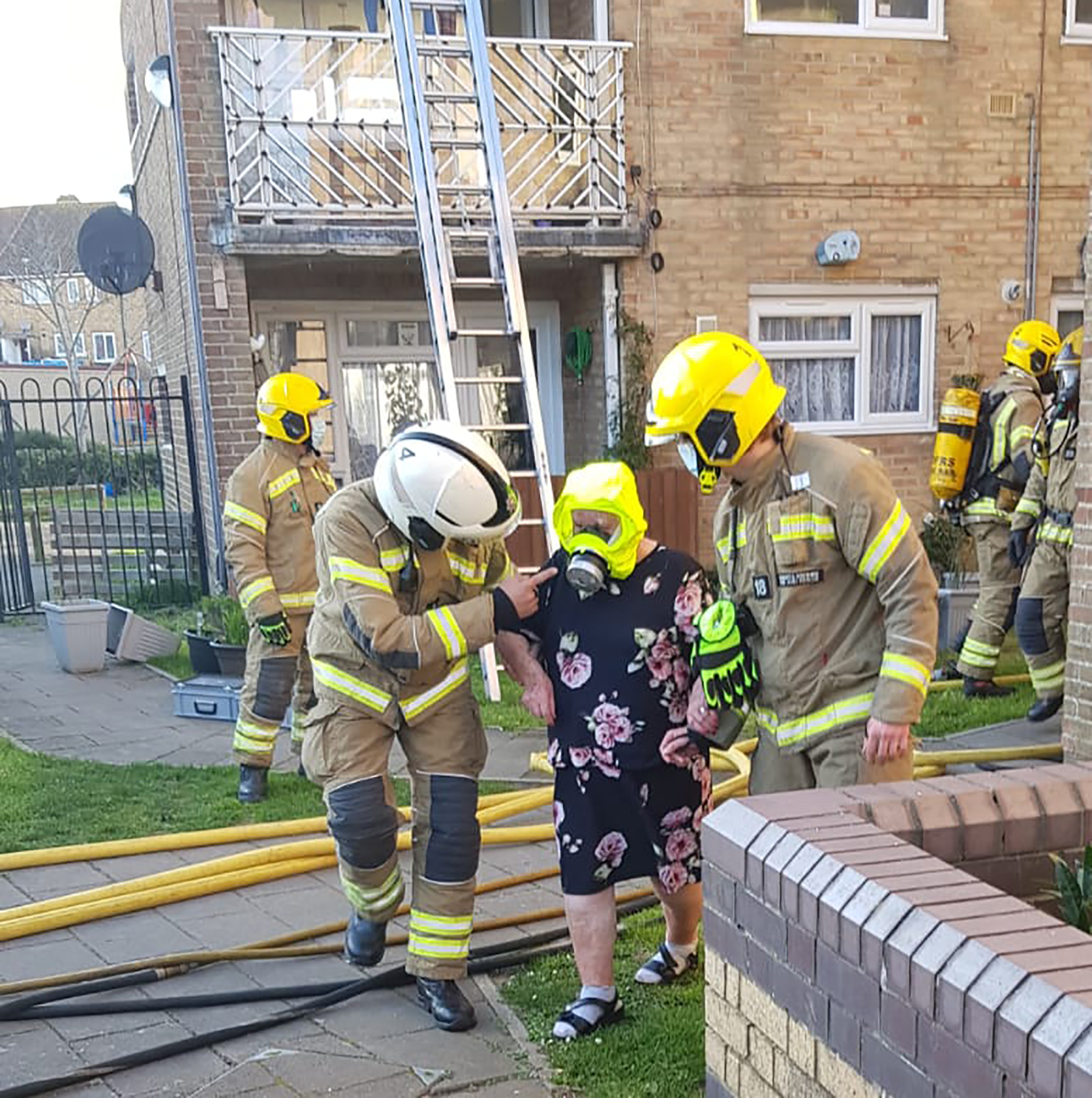 Resident of fire-affected property brought to safety wearing fire escape hood